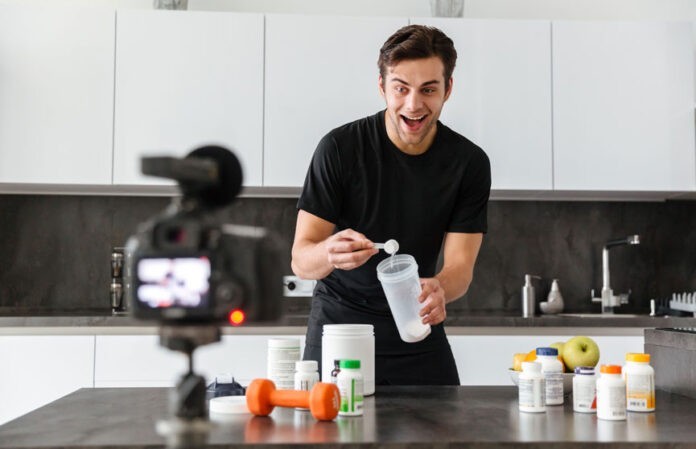 Excited young man filming his video blog episode